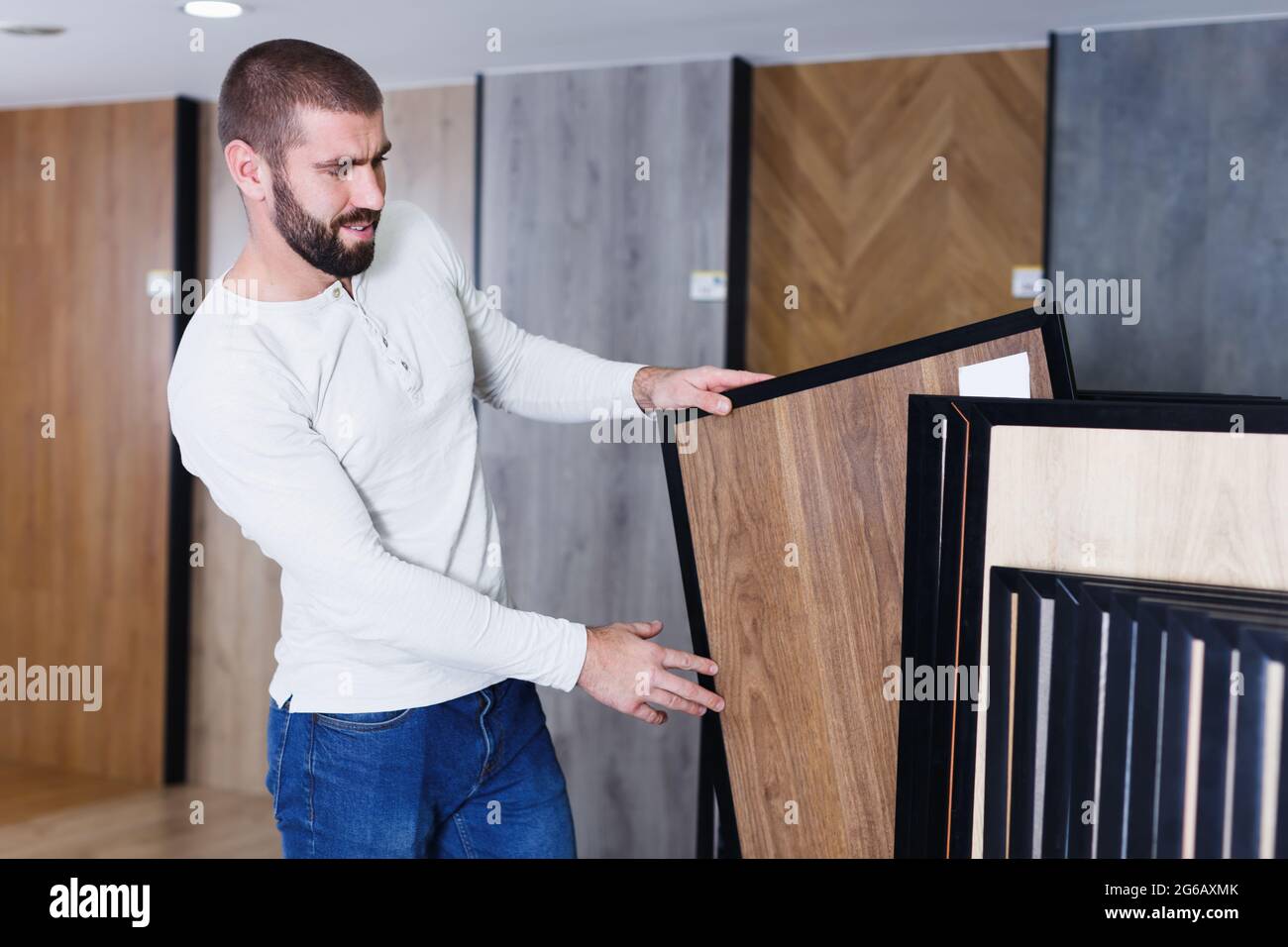 Portrait of young man choosing wood laminated flooring Stock Photo Alamy