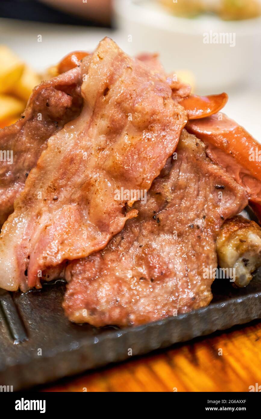Delicious American barbecue platter, steak, bacon, sausage and fries