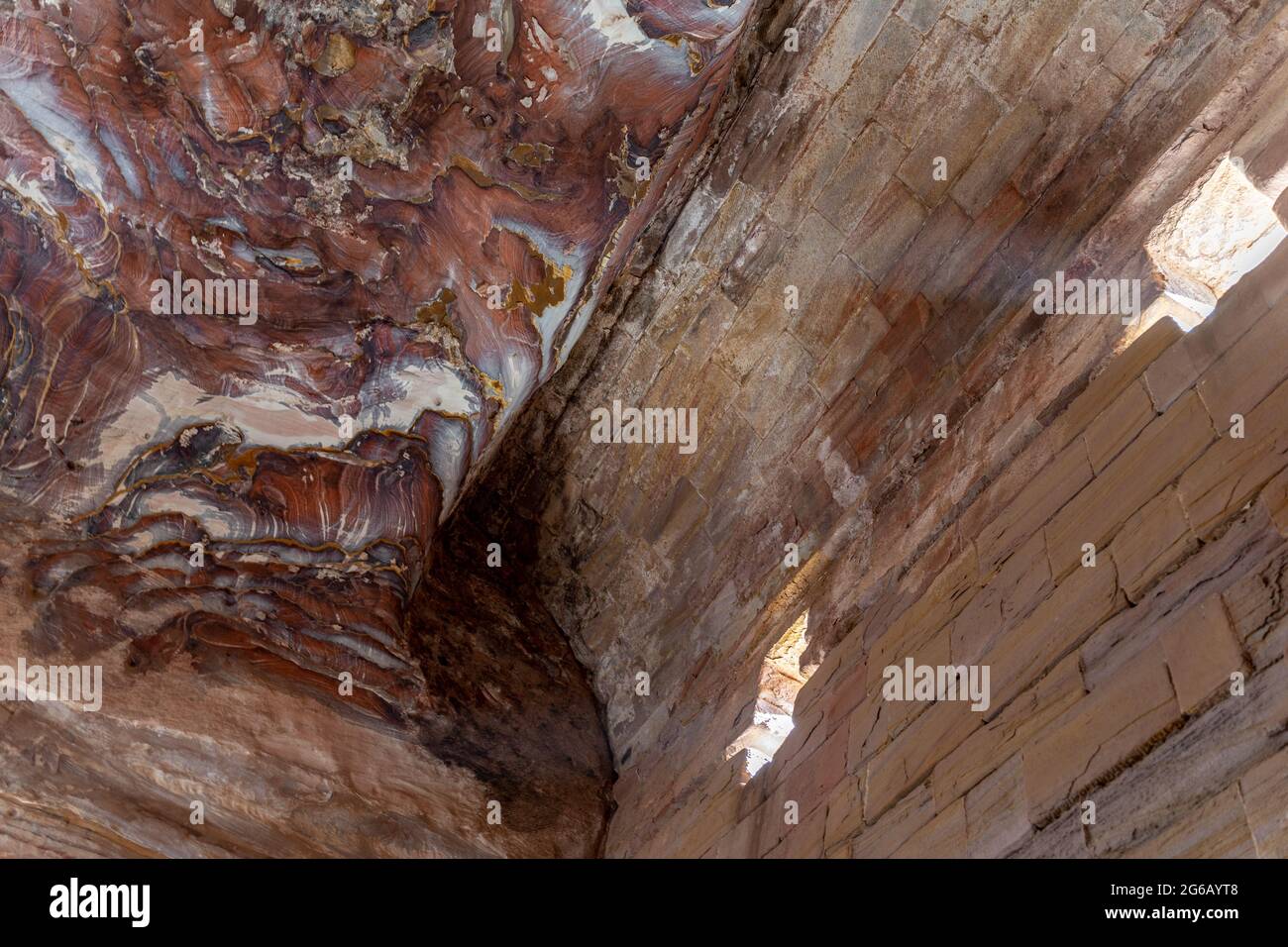 Multicolored redrose sandstone with signs of weathering and erosion, patterns and textures of