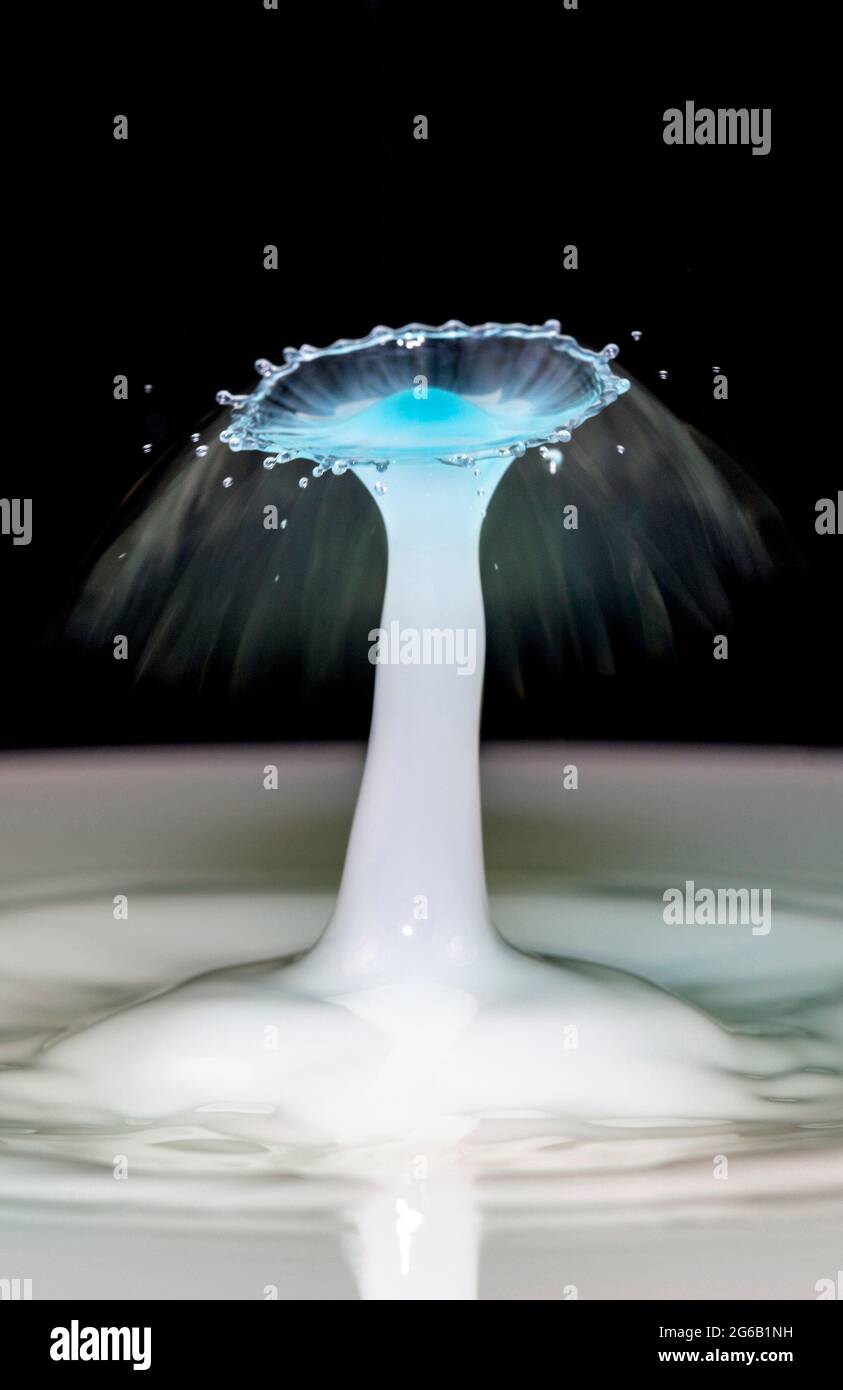 Blue water drop collision over a black background Stock Photo - Alamy