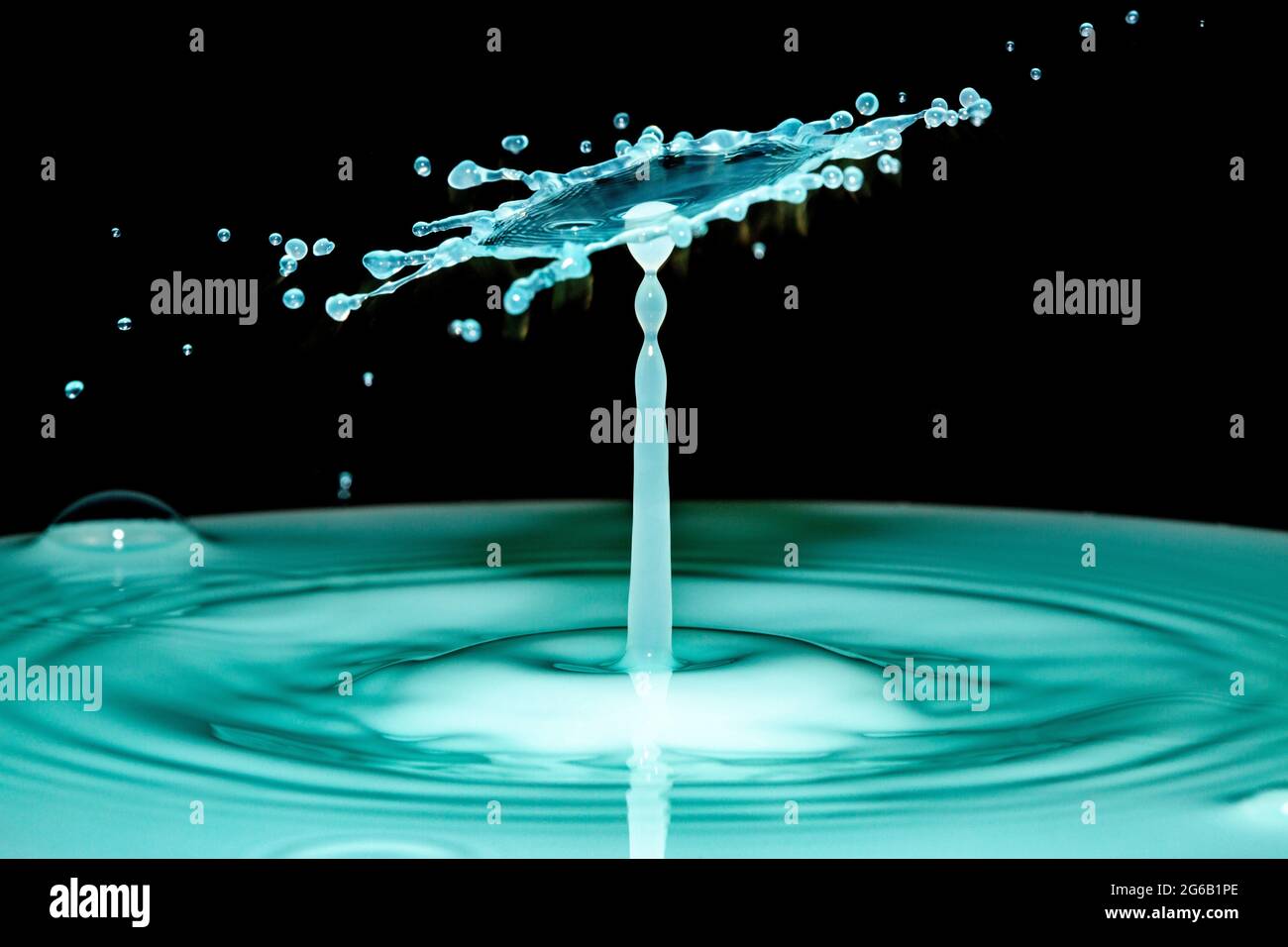 Blue water drop collision over a black background Stock Photo - Alamy