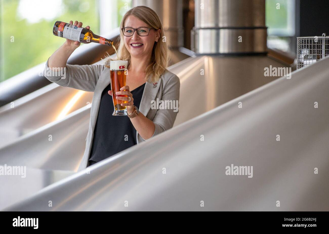 Stralsund, Germany. 30th June, 2021. Elisa Raus, the reigning world champion beer sommelier, pours a glass of beer in the brewhouse at Störtebeker Braumanufaktur. At the 2019 world championship in Rimini, Italy, she prevailed against the assembled competition from 19 nations. Due to the Corona pandemic, Raus may also be the longest reigning world champion. Credit: Jens Büttner/dpa-Zentralbild/dpa/Alamy Live News Stock Photo