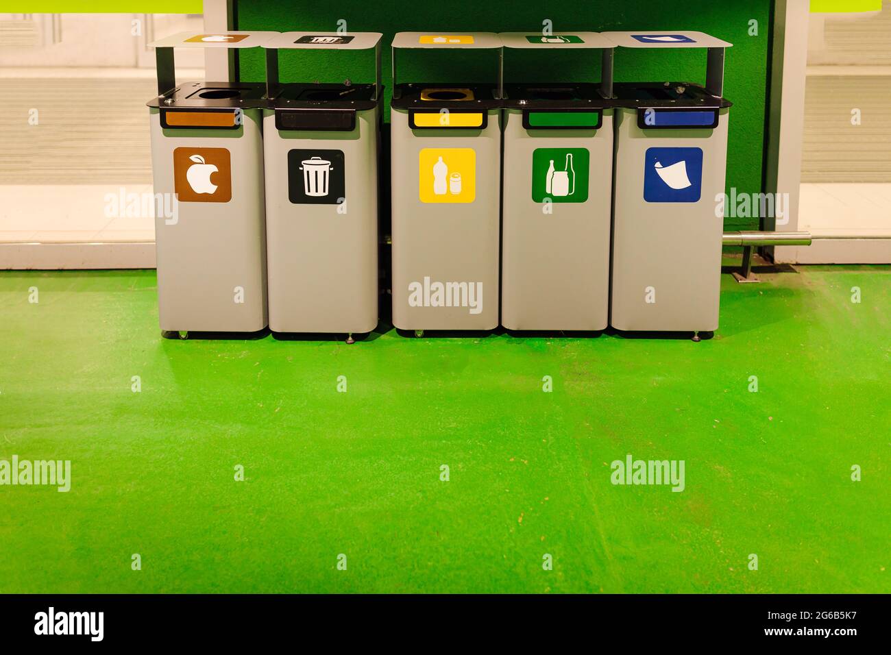 Neat, standing in row, containers for waste separation. Ecology and waste separation. Environmental pollution. Social consciousness. Lifestyle. Stock Photo