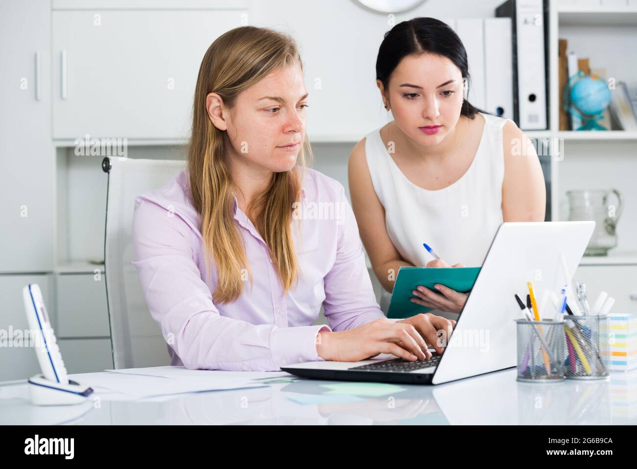 Manager inspecting work Stock Photo - Alamy