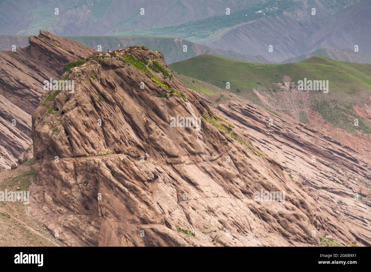 Distant view of Alamut Castle(fort), on steep hilltop, and Alborz mountains, Alamut, Qazvin Province, Iran, Persia, Western Asia, Asia Stock Photo