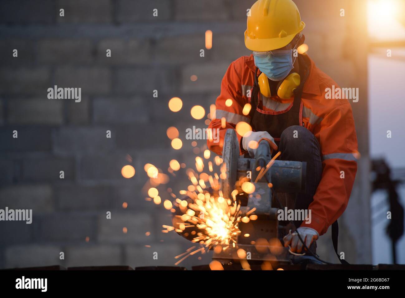 Manual working using a circular saw on a building site, Thailand Stock Photo