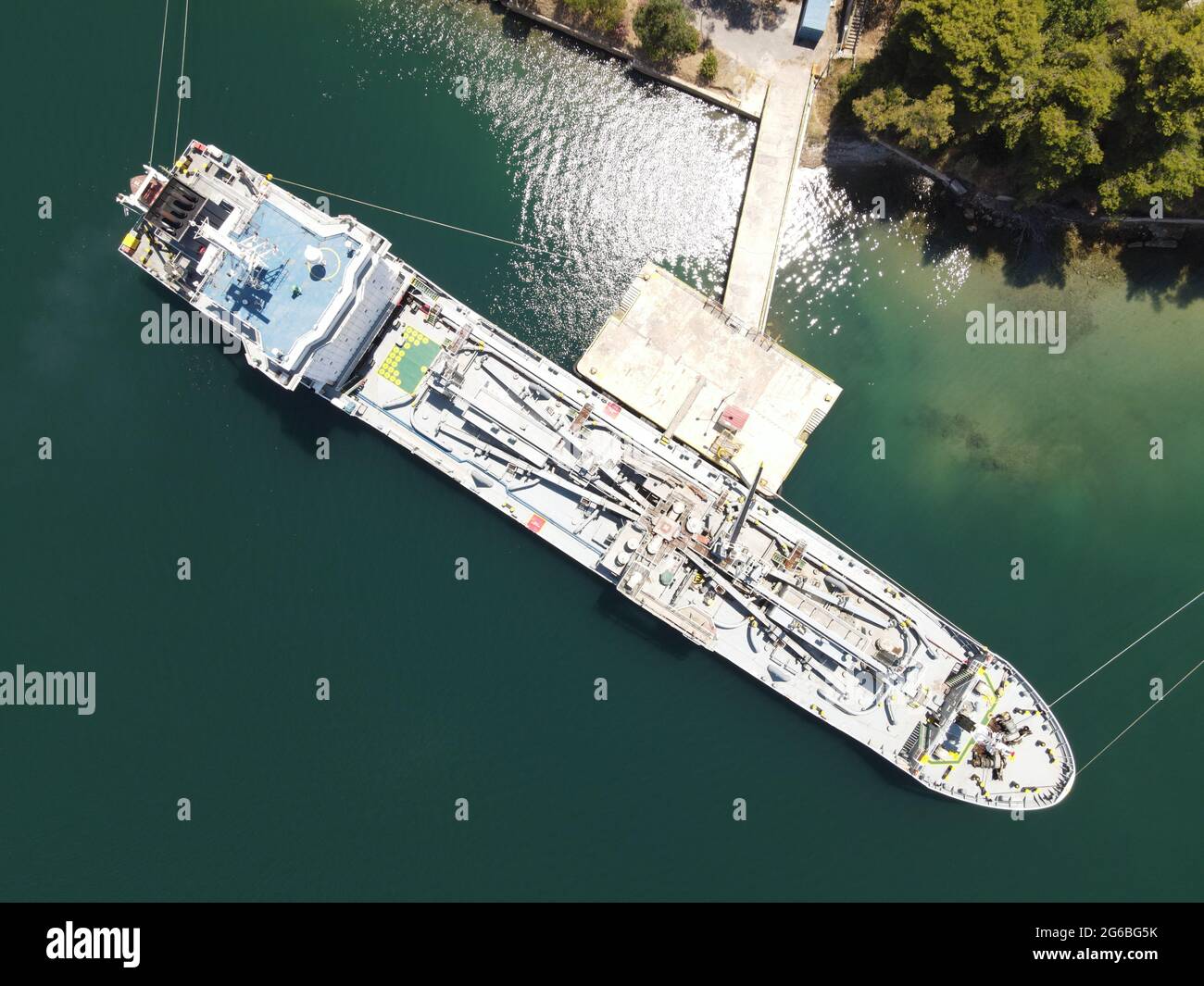 Aerial view seaven star cement, concrete carrirer industrial transport cargo ship from piraeus in port of igoumenitsa city greece with destination rio Stock Photo