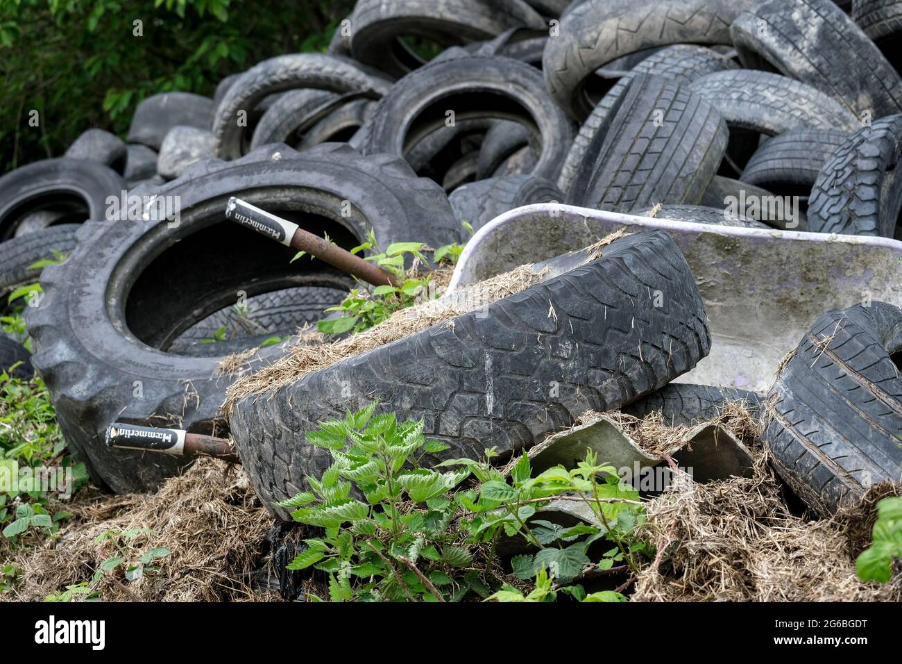 Pile of Tyres in a farnyard Stock Photo