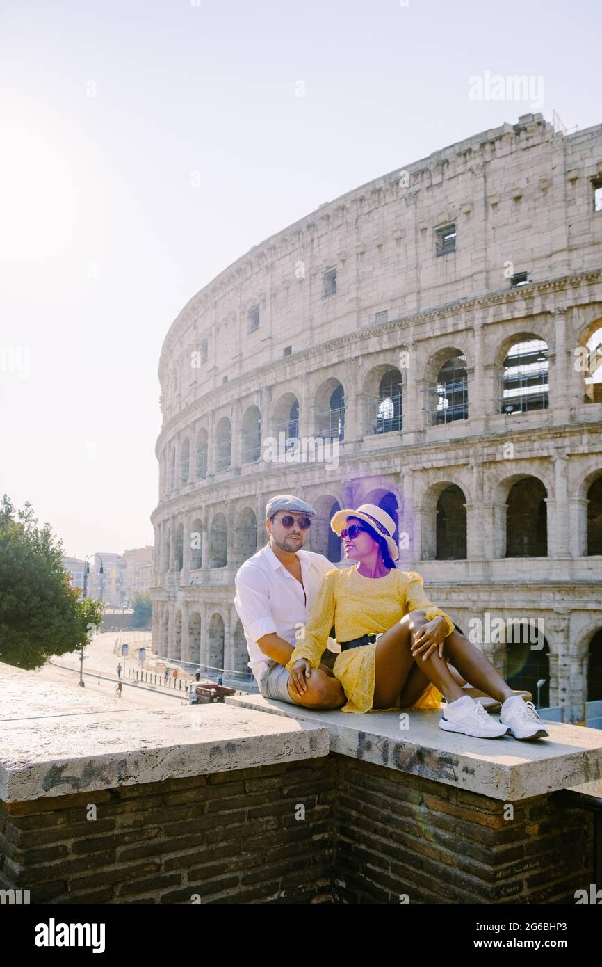 young couple mid age Asian woman and European man on a city trip in Rome Italy Europe, Colosseum Coliseum building in Rome, Italy Stock Photo