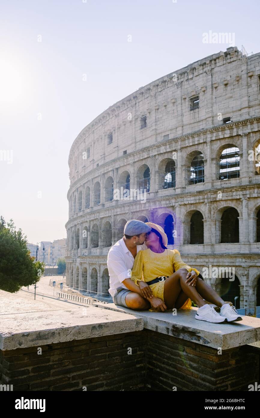 young couple mid age Asian woman and European man on a city trip in Rome Italy Europe, Colosseum Coliseum building in Rome, Italy Stock Photo