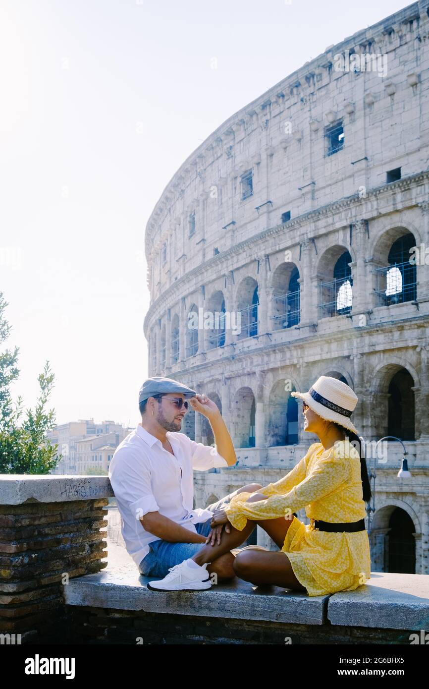 young couple mid age Asian woman and European man on a city trip in Rome Italy Europe, Colosseum Coliseum building in Rome, Italy Stock Photo