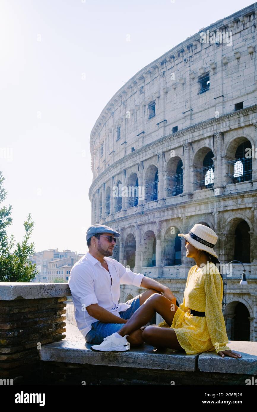 young couple mid age Asian woman and European man on a city trip in Rome Italy Europe, Colosseum Coliseum building in Rome, Italy Stock Photo