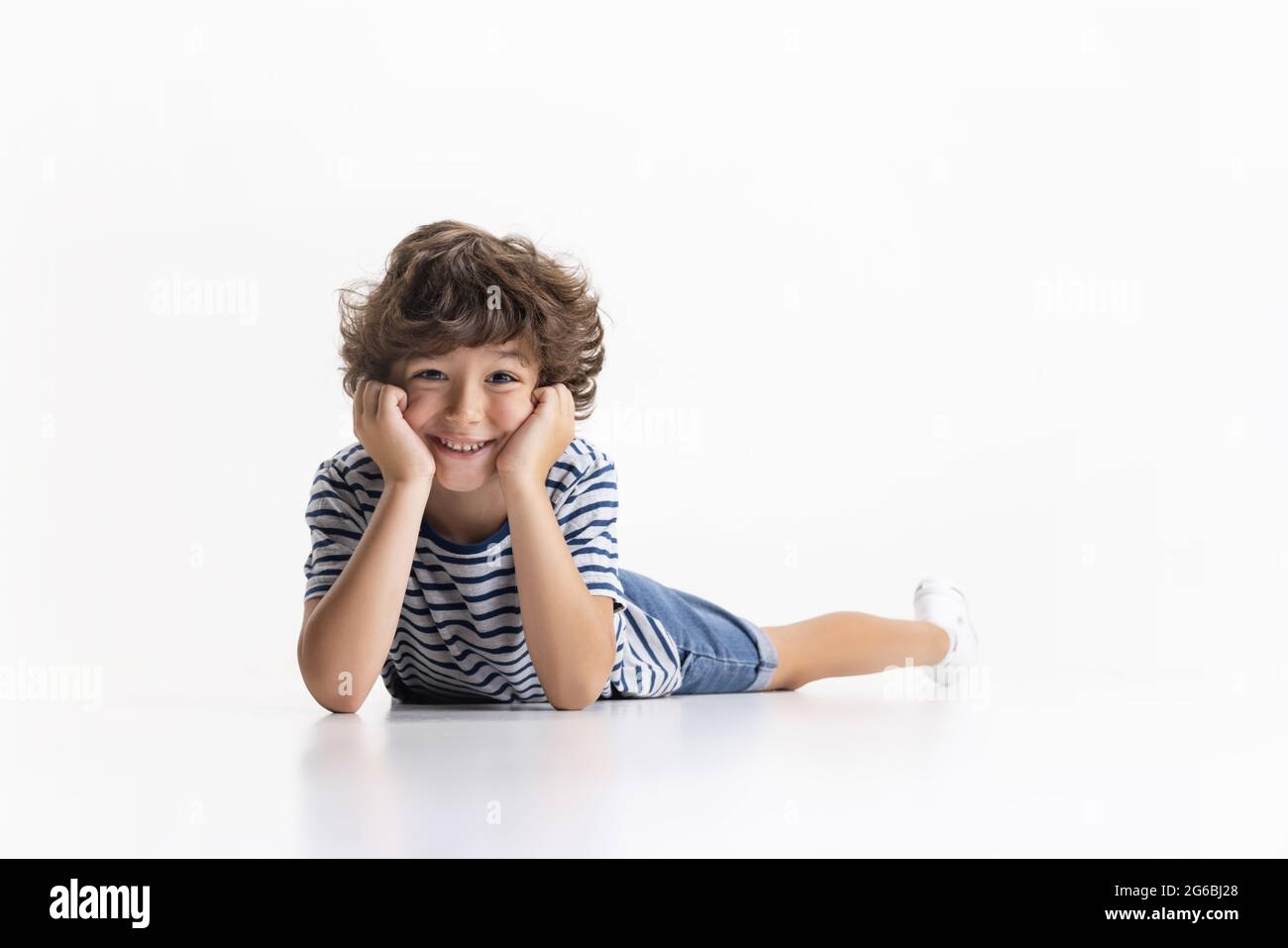 Portrait of little preschool boy posing isolated over white studio ...