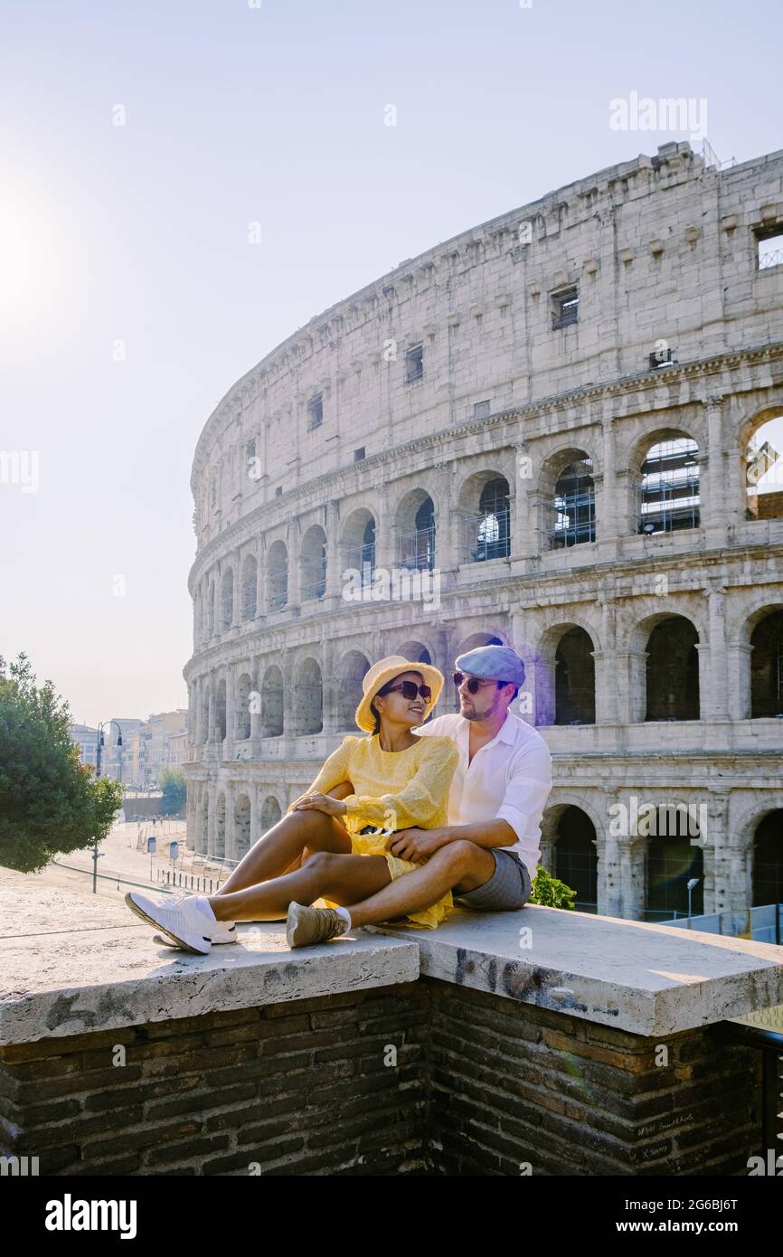 young couple mid age Asian woman and European man on a city trip in Rome Italy Europe, Colosseum Coliseum building in Rome, Italy Stock Photo