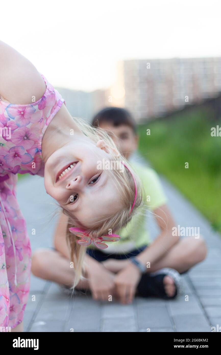 Brother and sister smiling portraits in a summer park Stock Photo - Alamy