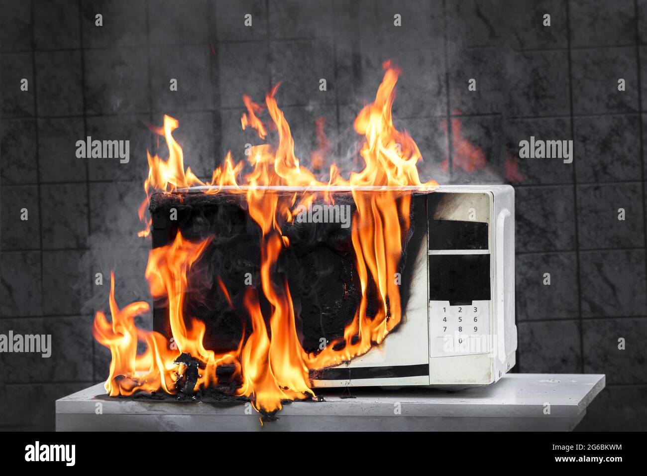 Microwave oven white, in fire front view, electrical appliances caught