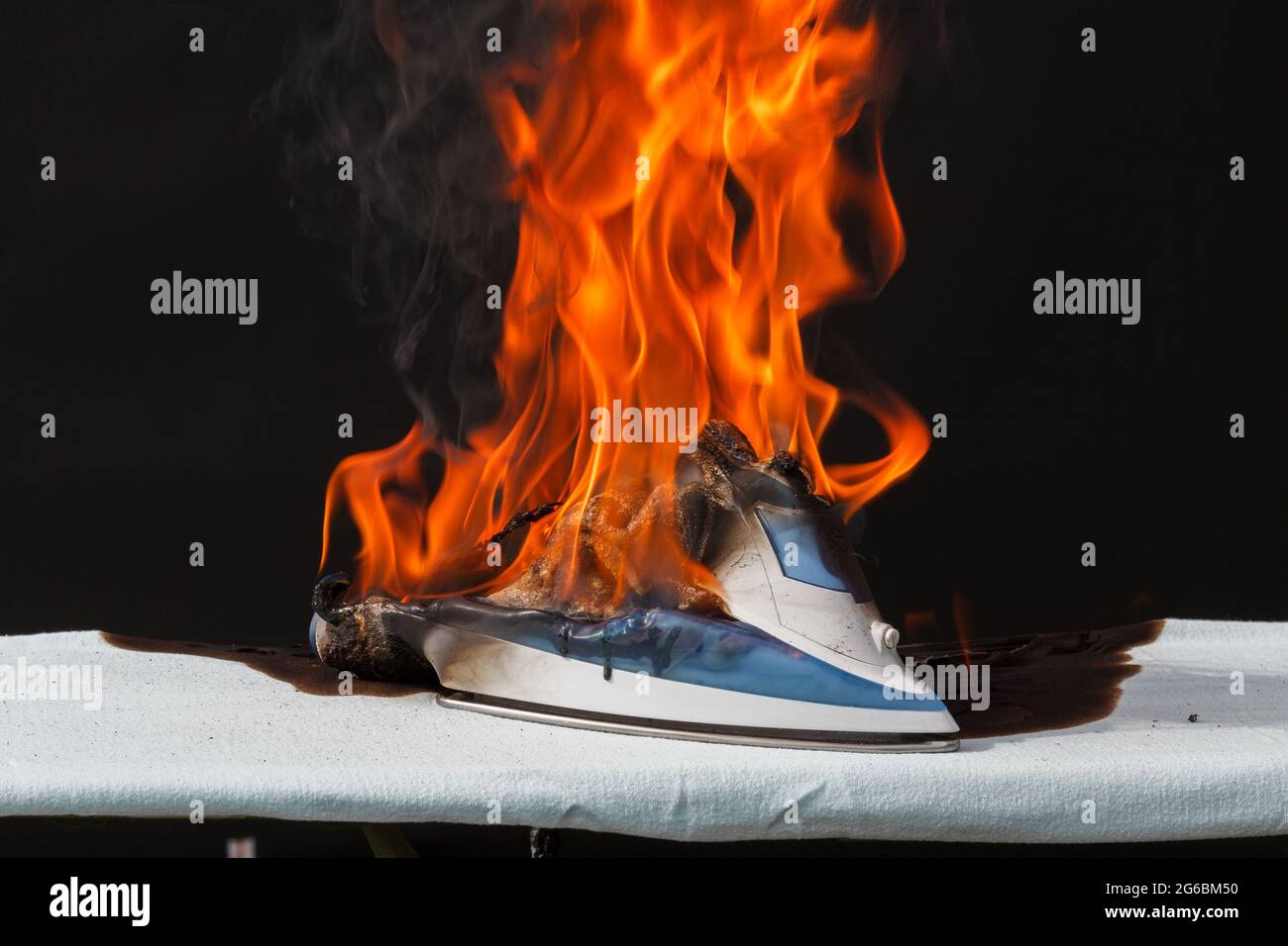Iron in flames of fire, faulty wiring, cause of fire Stock Photo Alamy