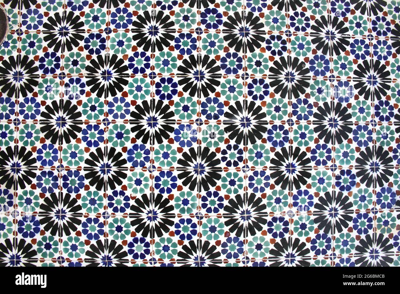 Glazed blue, black, green and red ceramic tiles or azulejos which cover many buildings in Lisbon, Portugal. Portuguese tiles with different designs. Stock Photo