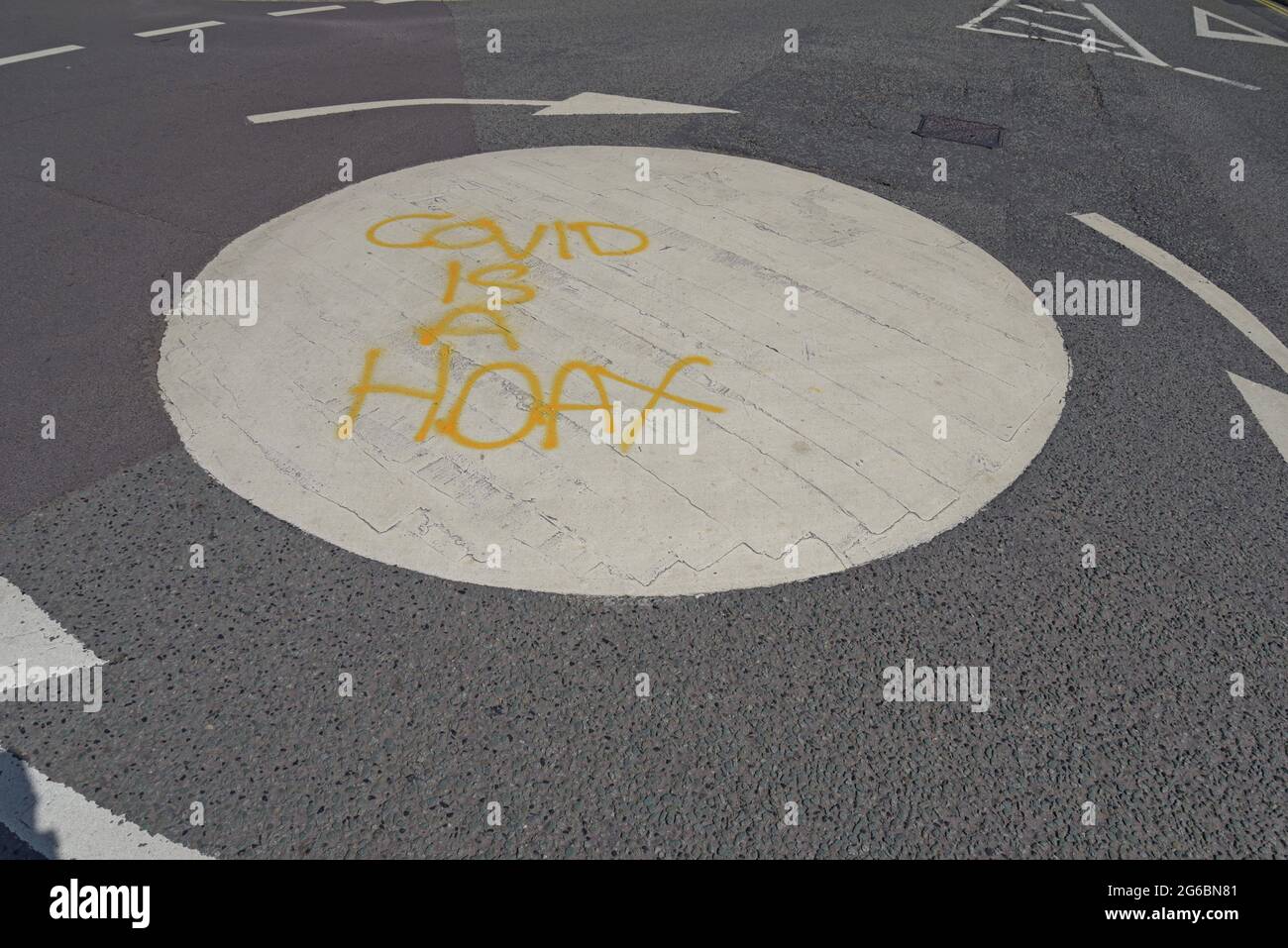 'Covid is a hoax' spray painted on a roundabout in Ironbridge, near Telford UK, by Covid deniers, June 2021 Stock Photo