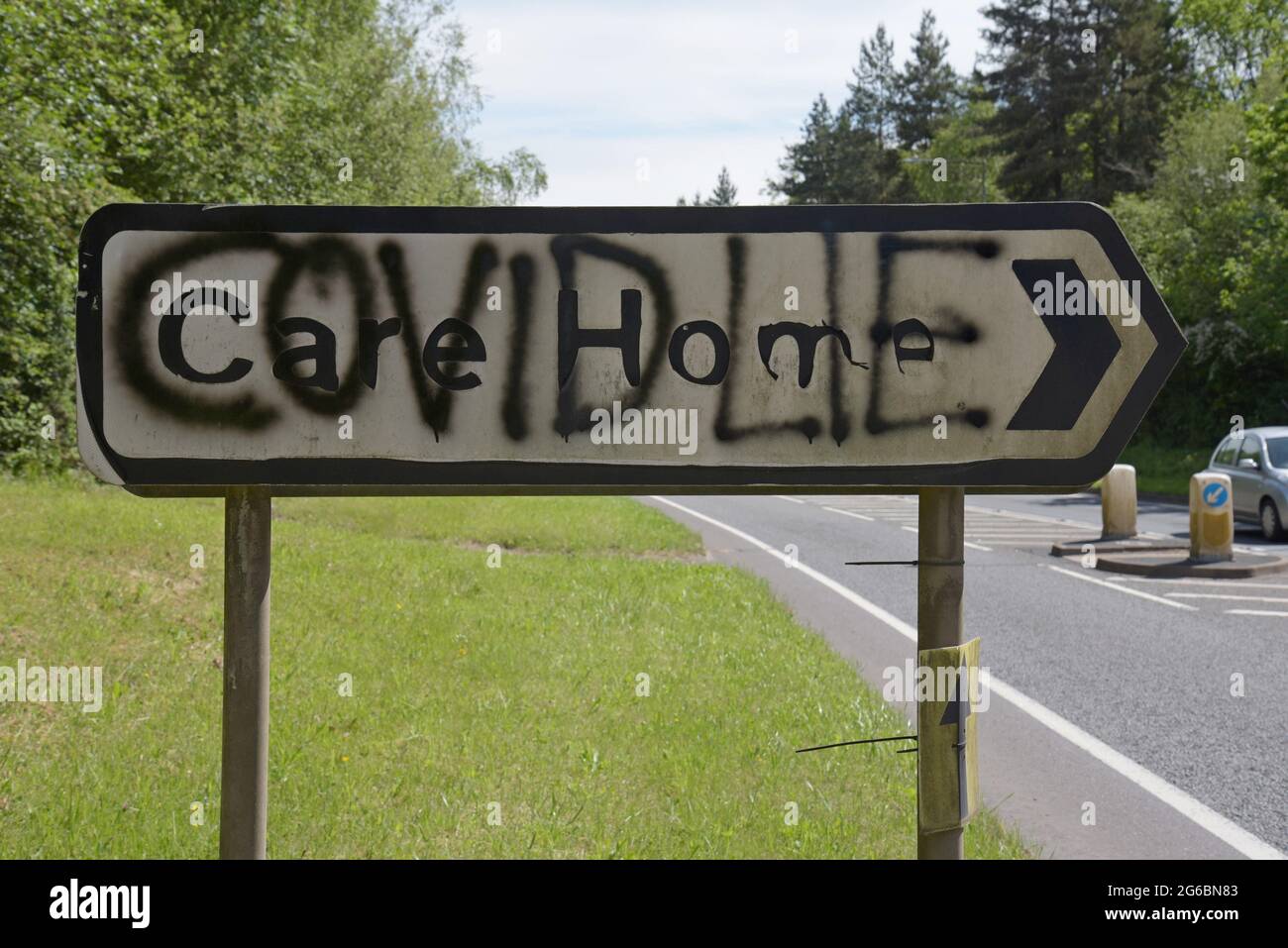 'Covid Lies' spray painted on a road sign to a care home in Ironbridge, near Telford UK, by Covid deniers, June 2021 Stock Photo