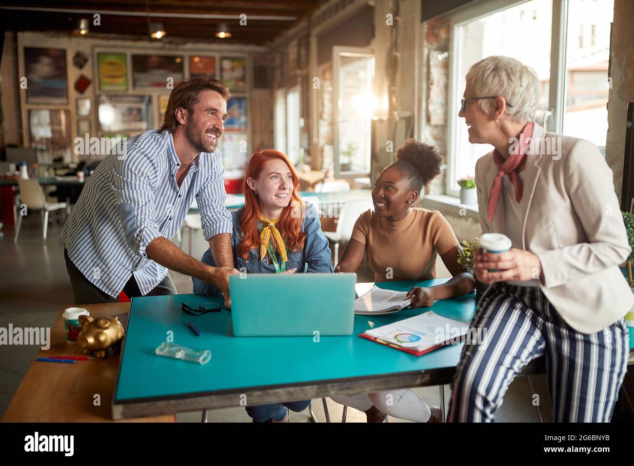 Group of employees are in a good mood while working in a friendly atmosphere in the office together Stock Photo
