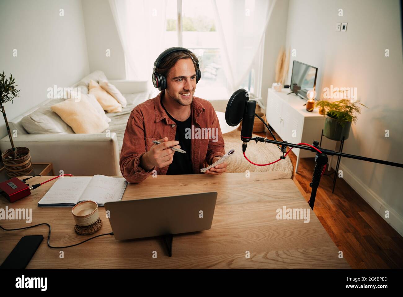Caucasian male freelance worker speaking on podcast for audience  Stock Photo