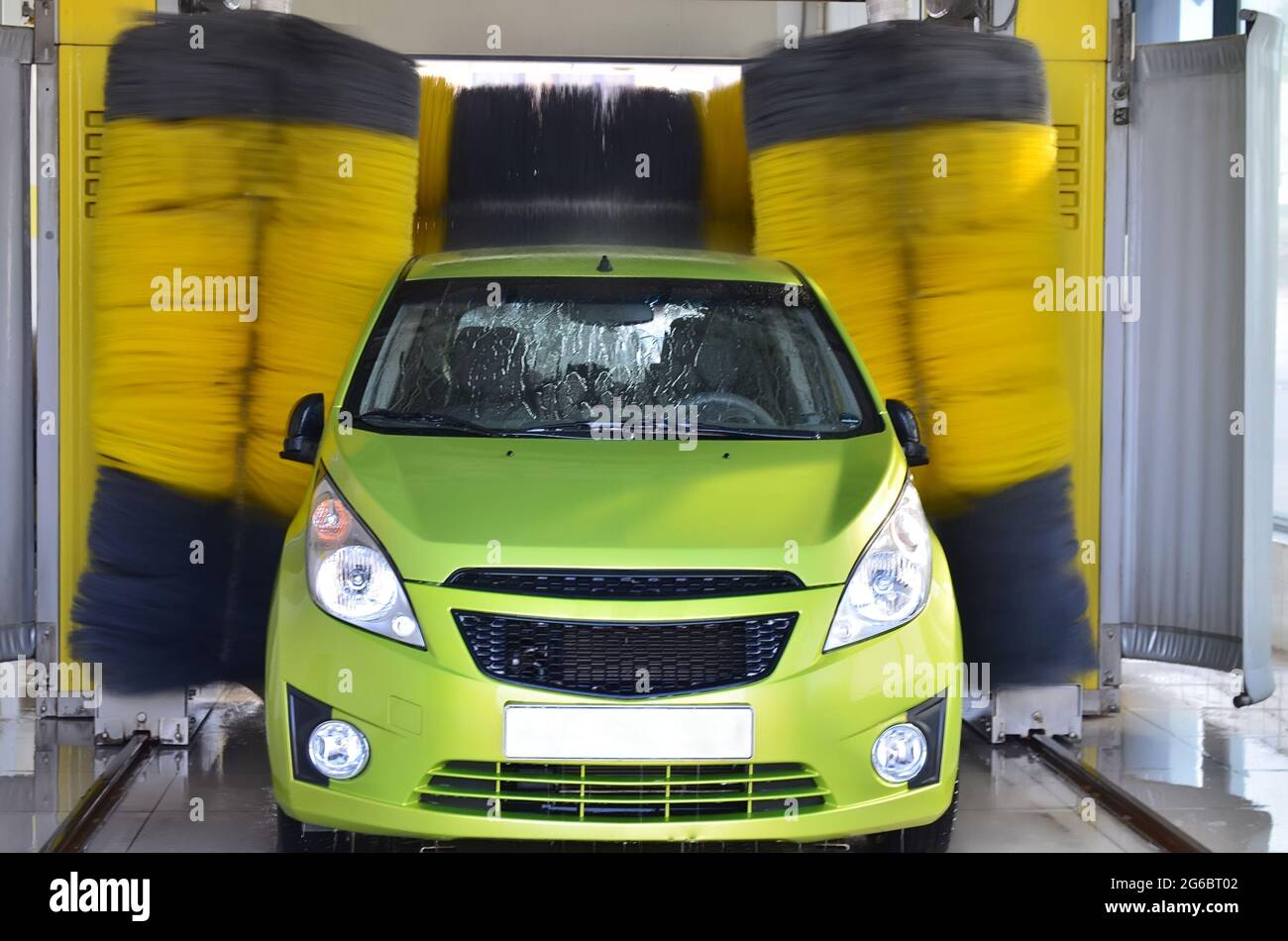 Automatic car wash with washable wet green car Stock Photo