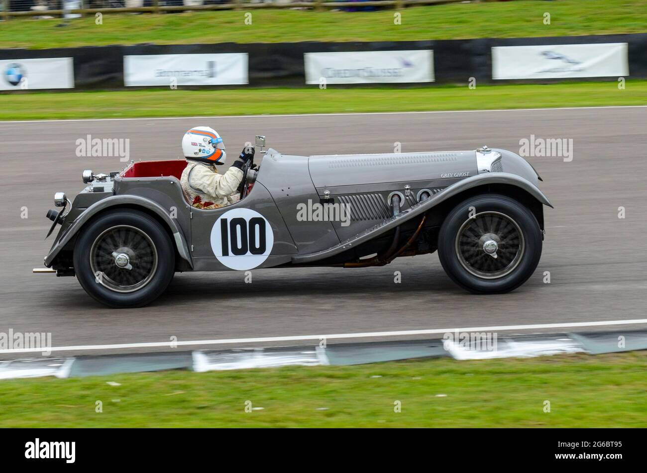 SS Jaguar 100 classic, vintage racing car competing in the Brooklands Trophy at the Goodwood Revival historic event, UK. Driven by Anthony Hancock Stock Photo