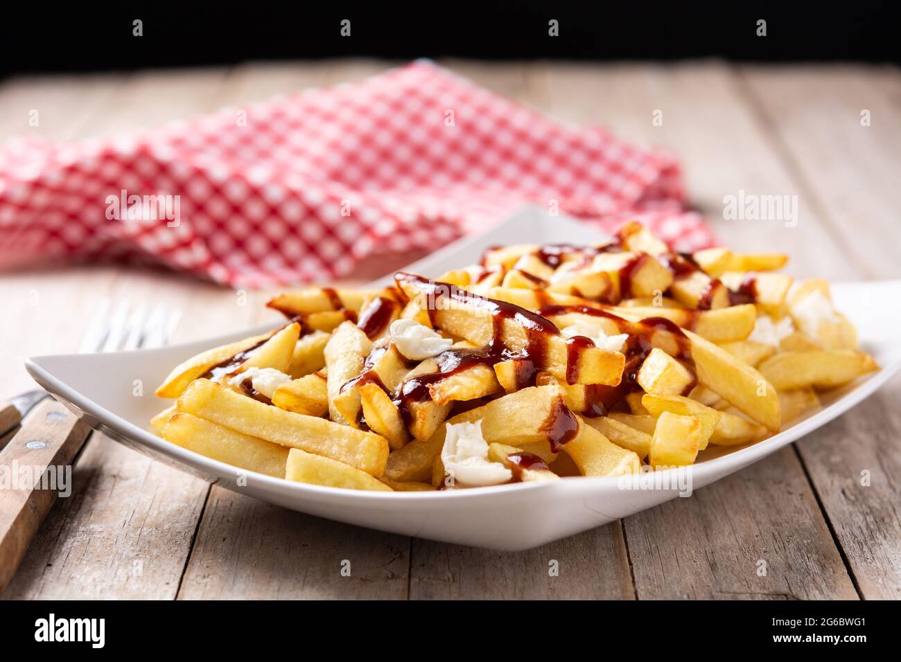 traditional-canadian-poutine-on-wooden-tablecloseup-stock-photo-alamy