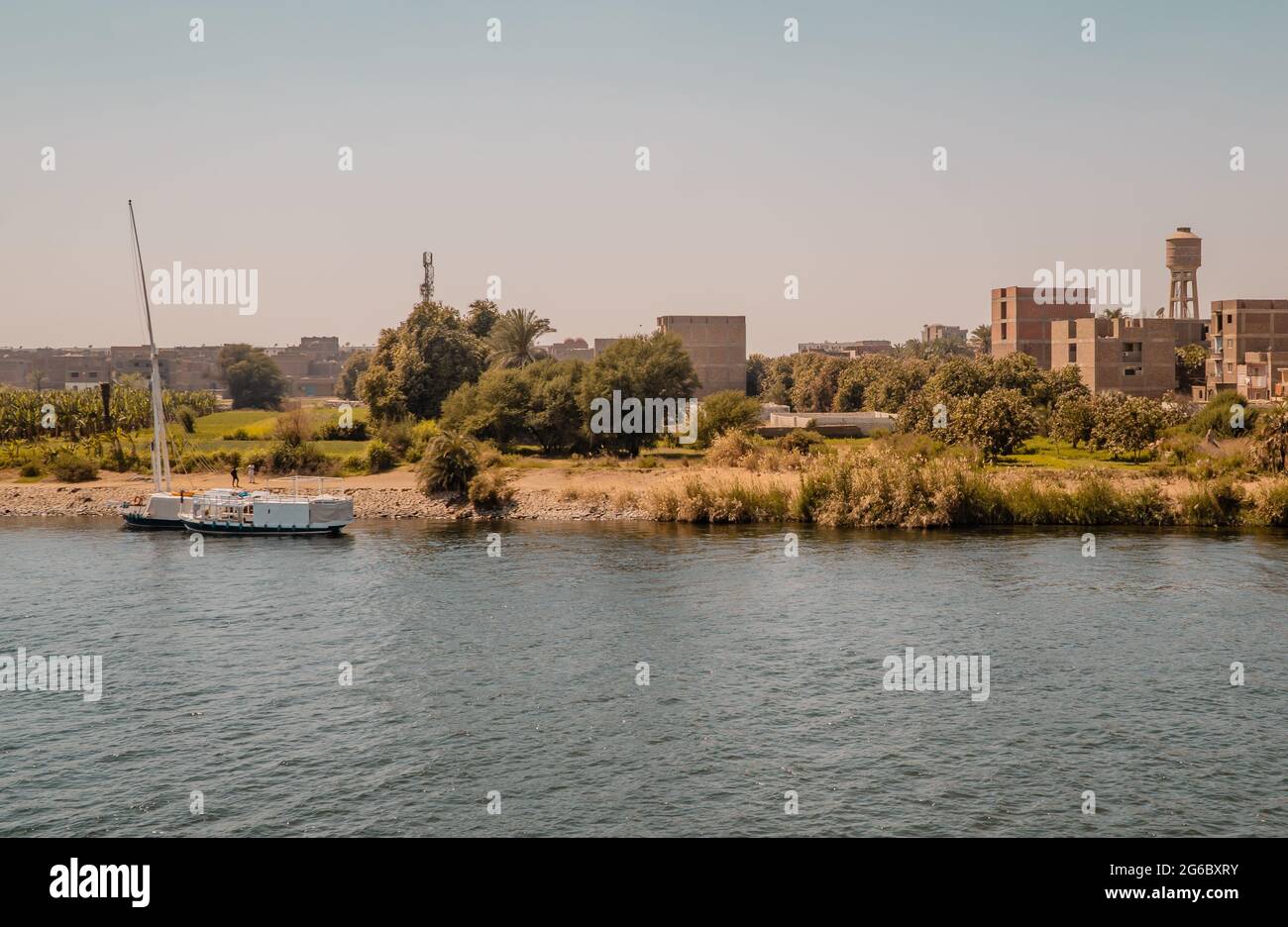 Panoramic view of houses in a traditional village at sunset on the Nile River near Edfu, Egypt Stock Photo