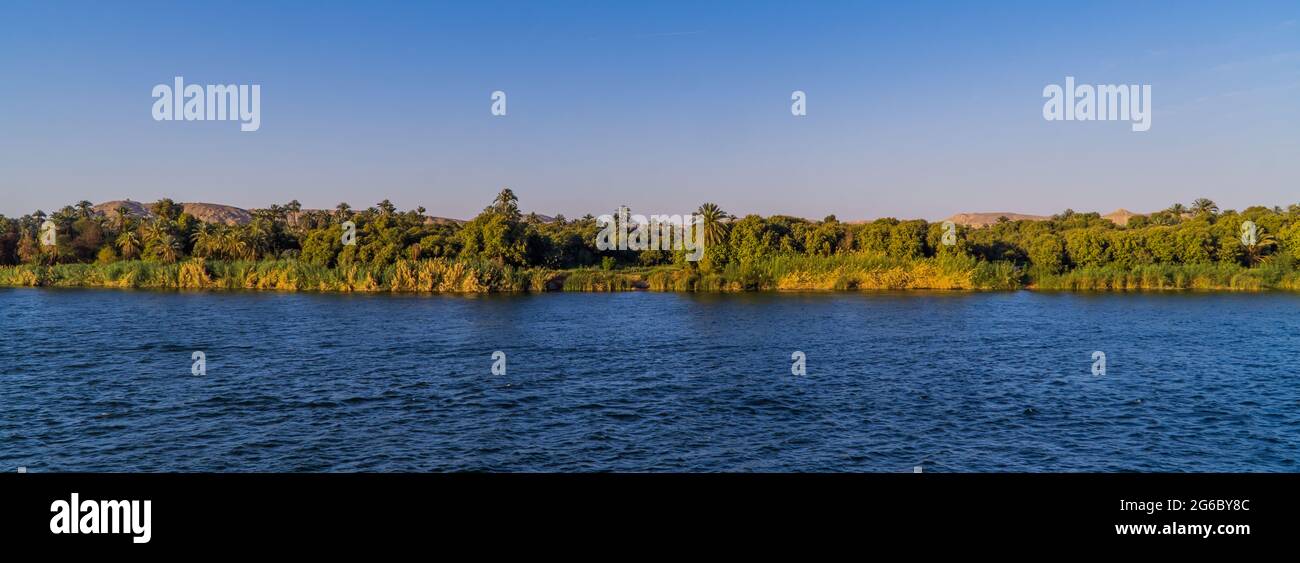 Panoramic view of houses in a traditional village at sunset on the Nile ...