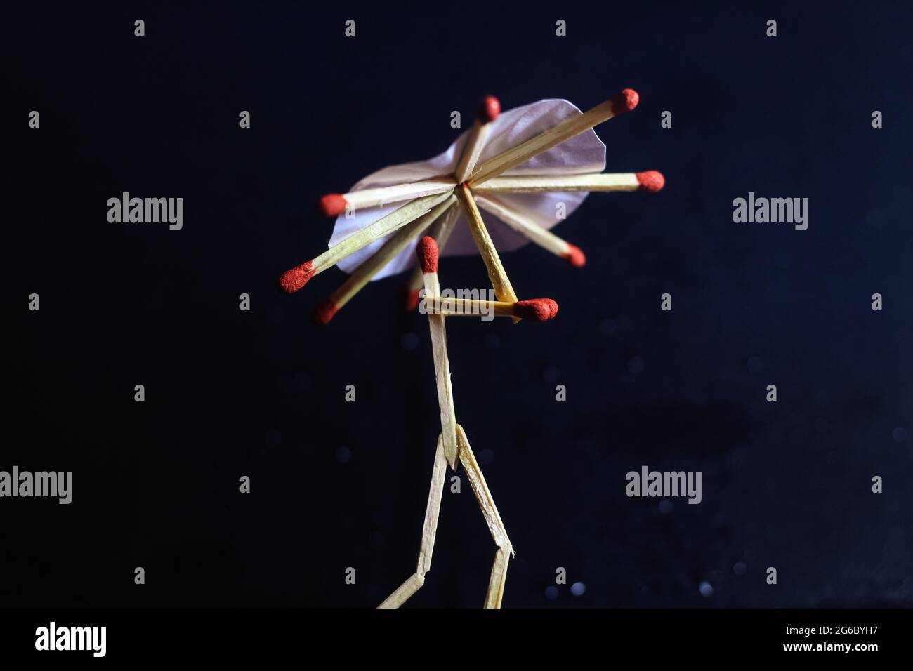 A matchstick man with a matchstick umbrella in the rain. Raining ...