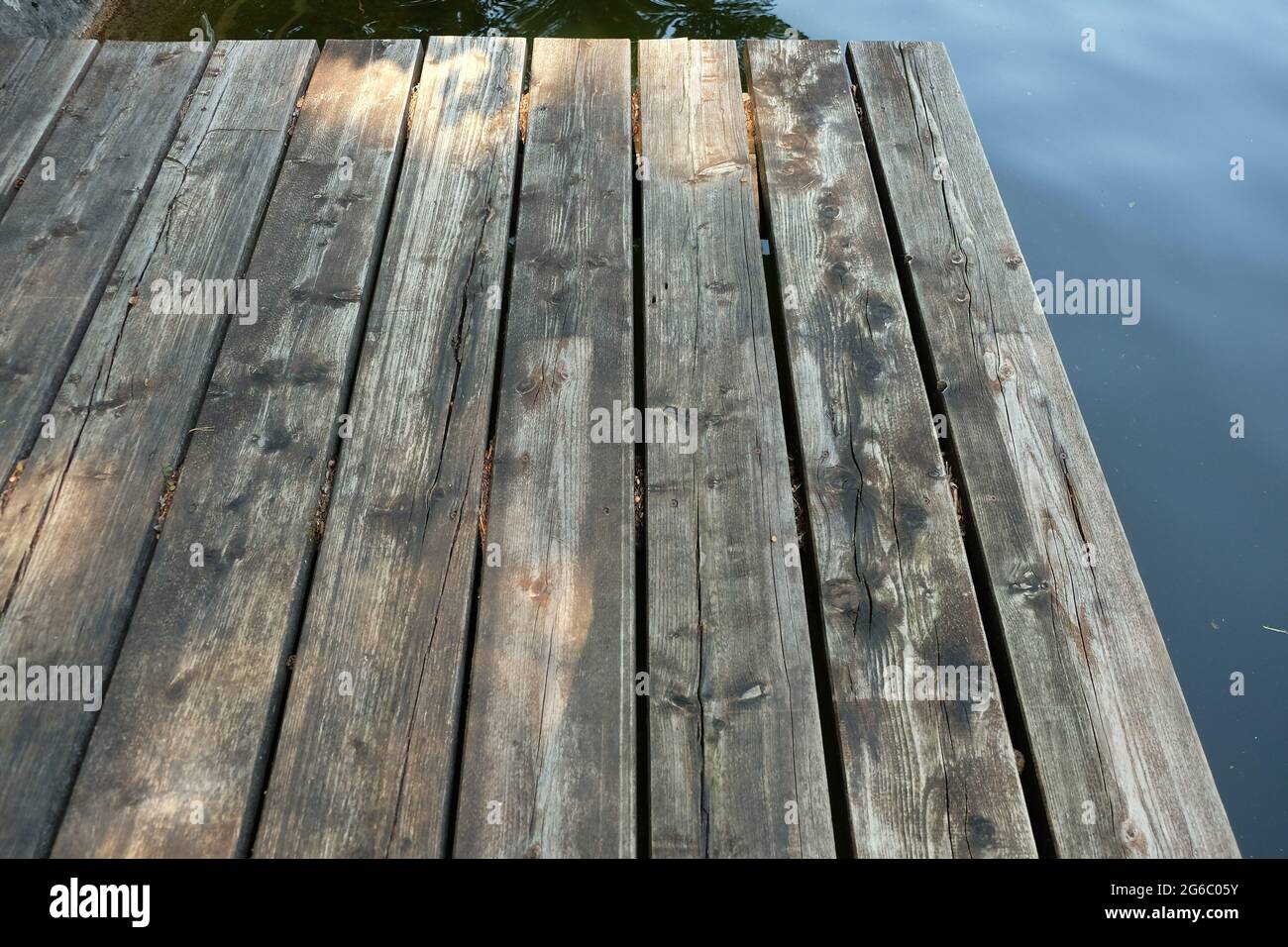 Closeup shot of a wooden jetty over the river Stock Photo - Alamy