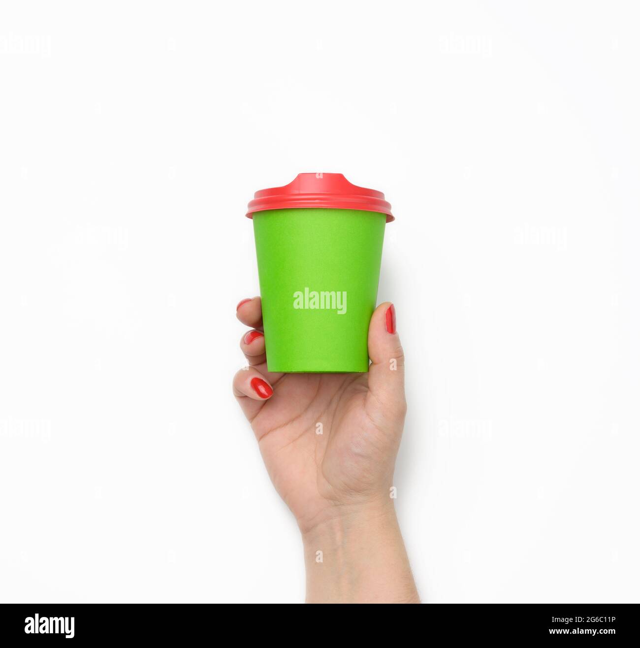 female hand holding disposable green paper cup isolated on white ...