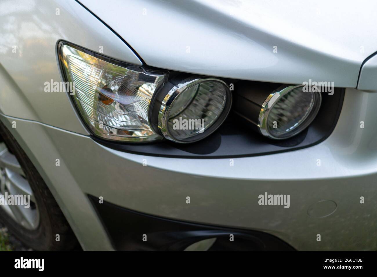 Car headlight on a gray car close-up Stock Photo