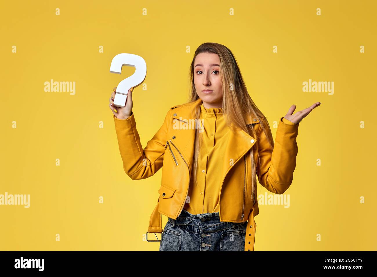 beautiful woman with question mark on studio background Stock Photo - Alamy