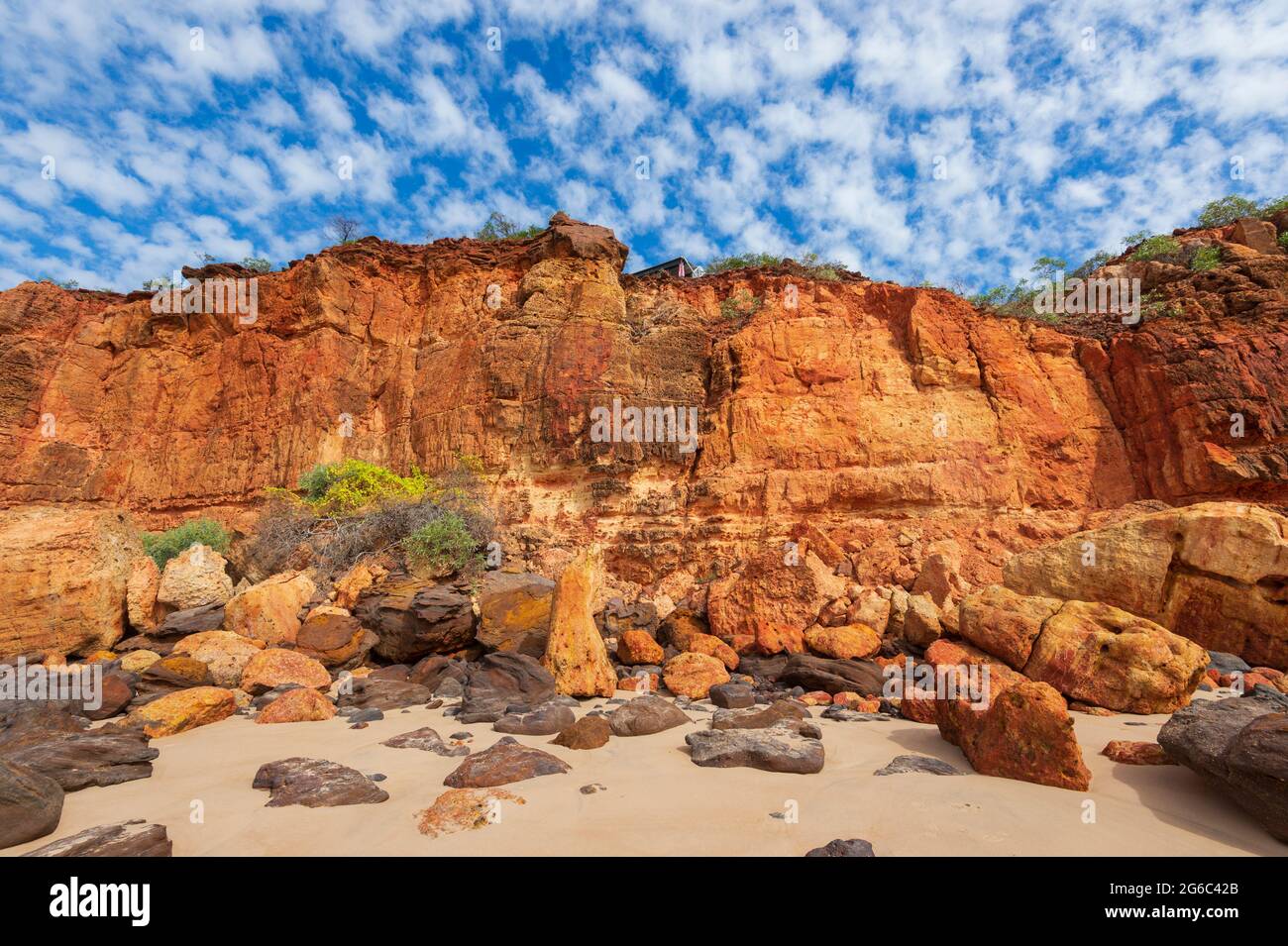 Spectacular view of red Pindan cliffs under a mackerel sky at Pender Bay Escape, Dampier Peninsula, Western Australia Stock Photo