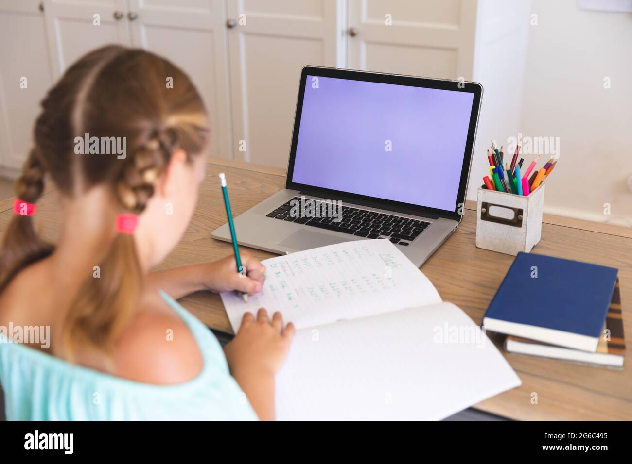Caucasian girl having video call during class on laptop with copy space ...