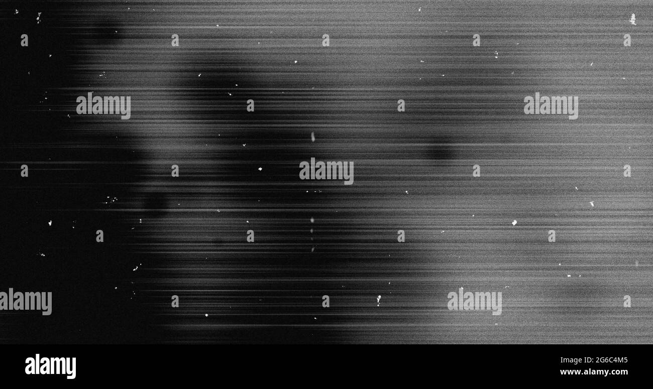 Image of multiple white specks and lines moving on seamless loop in black and white Stock Photo