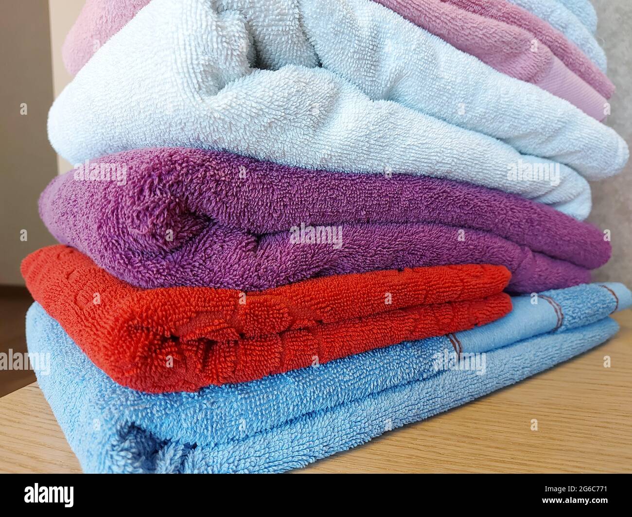 Multicolored cotton terry towels are stacked Stock Photo Alamy