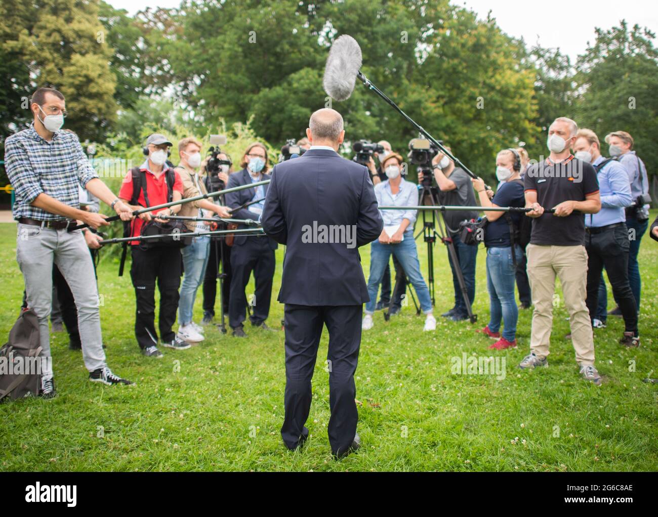 Langenhagen, Germany. 05th July, 2021. Olaf Scholz (SPD, M), SPD candidate for chancellor and federal finance minister, talks to journalists after visiting a school. Credit: Julian Stratenschulte/dpa/Alamy Live News Stock Photo
