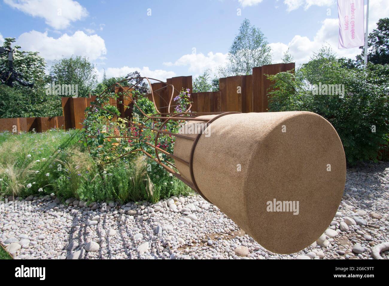 Hampton Court, England, 2 July 2021: Bill Bailey on the Canal and Rivers Trust show garden with it's message in a bottle. He is supporting their campaign against plastic pollution and littering. Rachel Royse/Alamy Live News Stock Photo