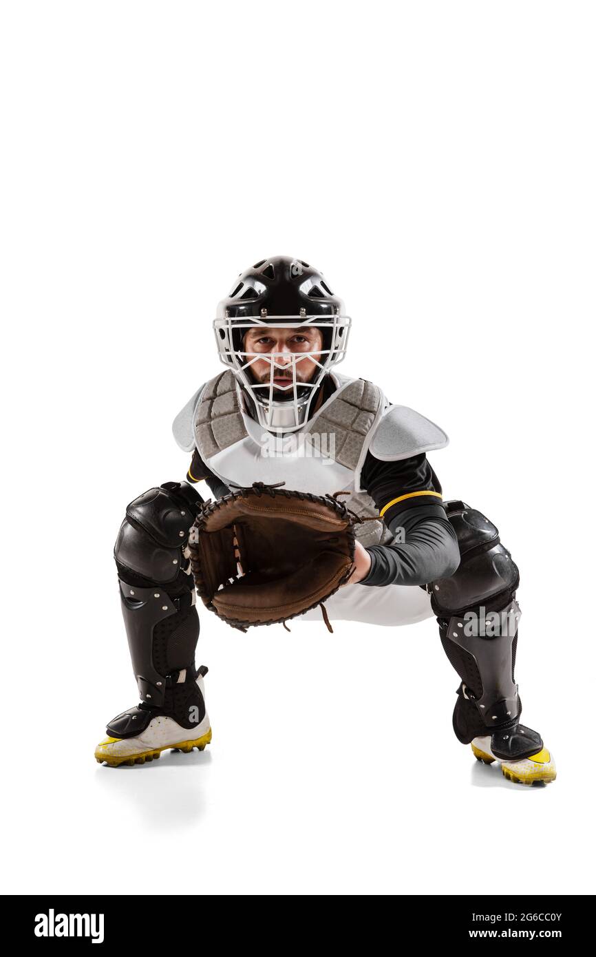 Baseball player, catcher in white sports uniform and equipment practicing isolated on a white studio background. Stock Photo