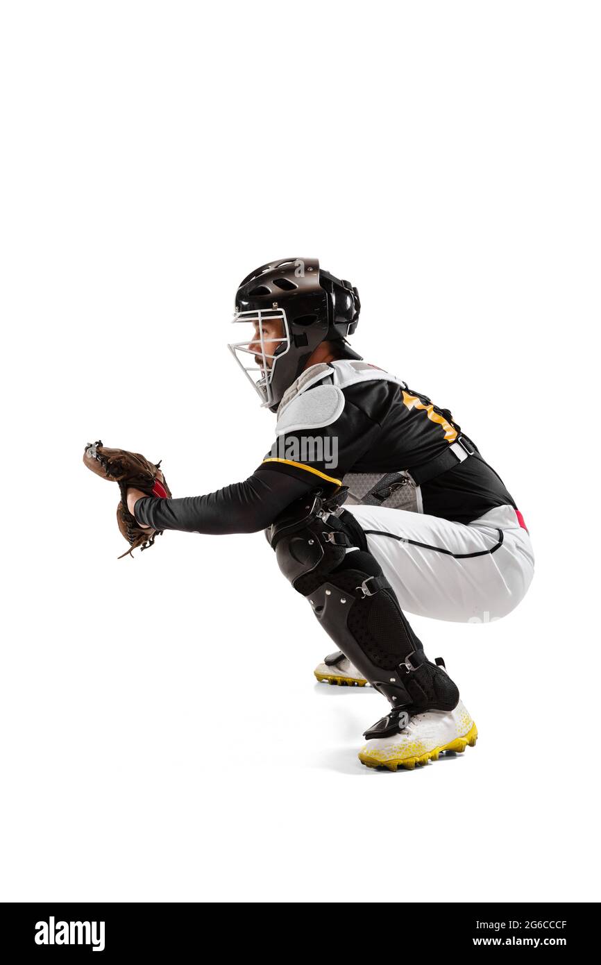 Baseball player, catcher in white sports uniform and equipment practicing isolated on a white studio background. Side view Stock Photo