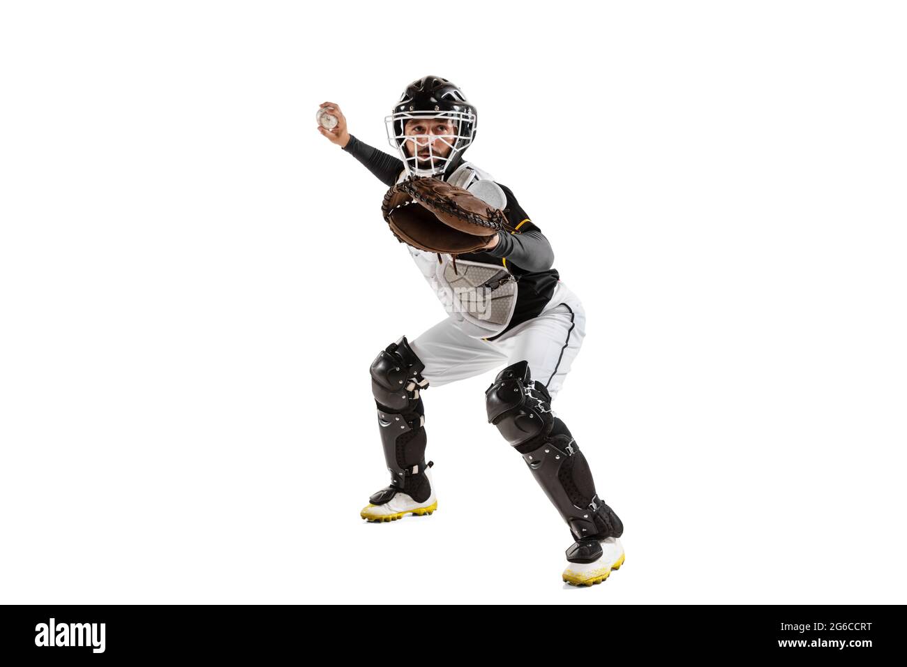 Baseball player, catcher in action in white sports uniform and equipment practicing isolated on a white studio background. Side view Stock Photo