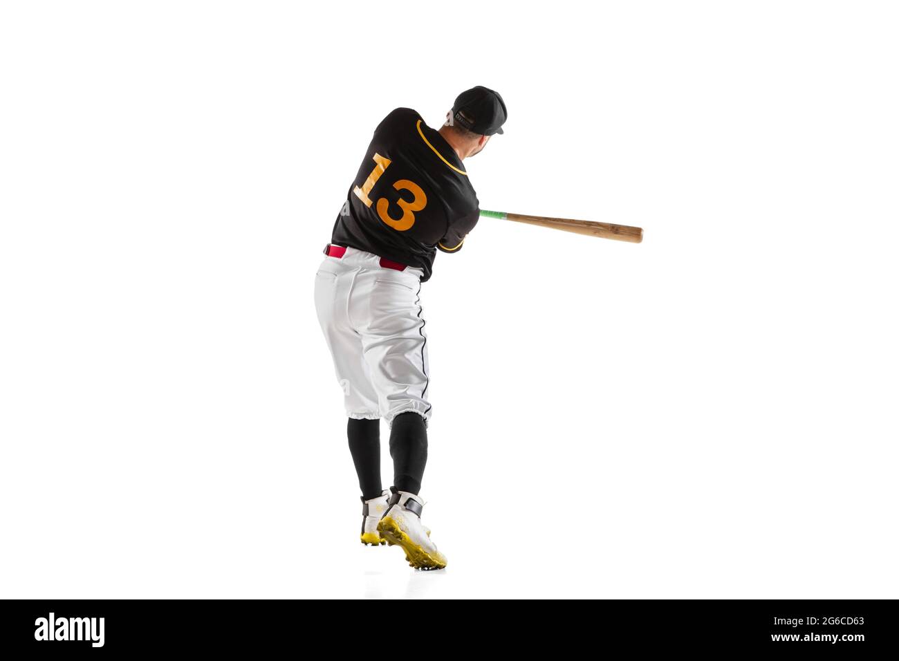 Baseball player, pitcher in a black white sports uniform practicing isolated on a white studio background. Back view Stock Photo
