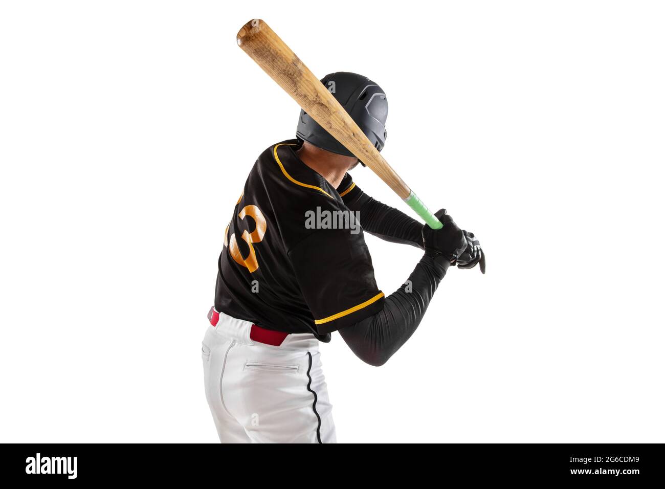 Baseball player, pitcher in a black white sports uniform practicing isolated on a white studio background. Back view Stock Photo