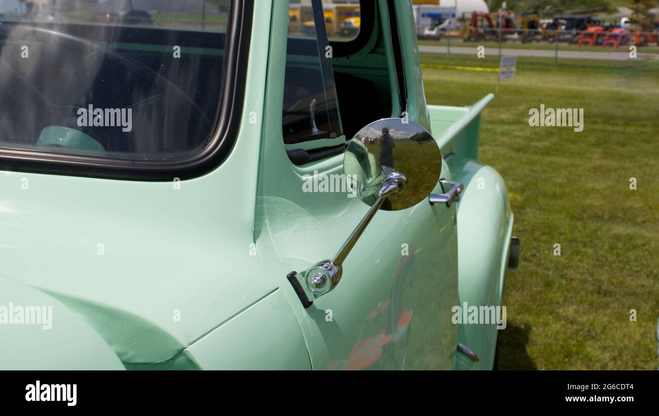 A Side View Mirror on an Old Pickup Truck Stock Photo