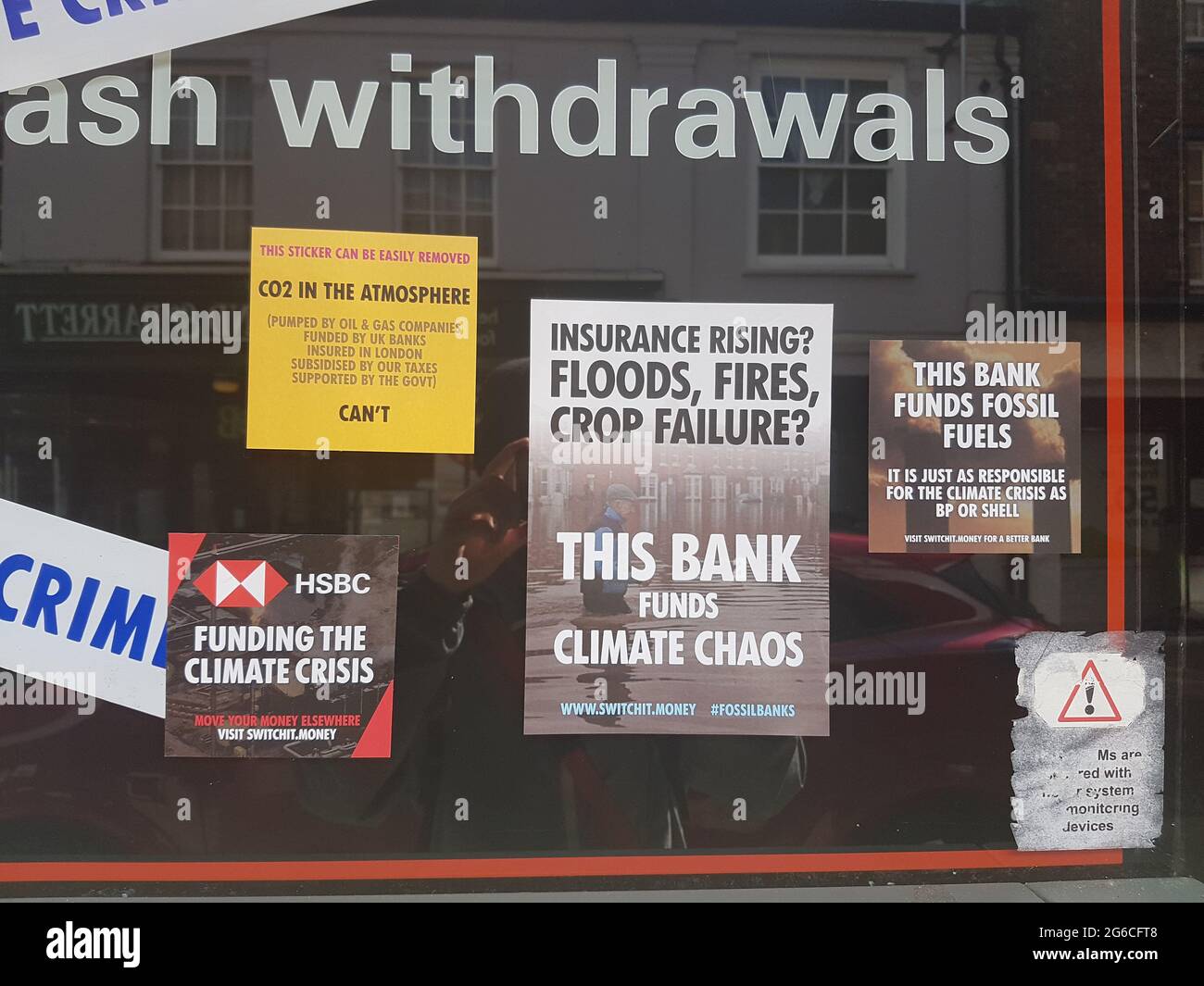Woodbridge, Suffolk, UK July 05 2021: Extinction rebellion poster that has been put up on the walls of a HSBC bank claiming they fund climate crisis Stock Photo