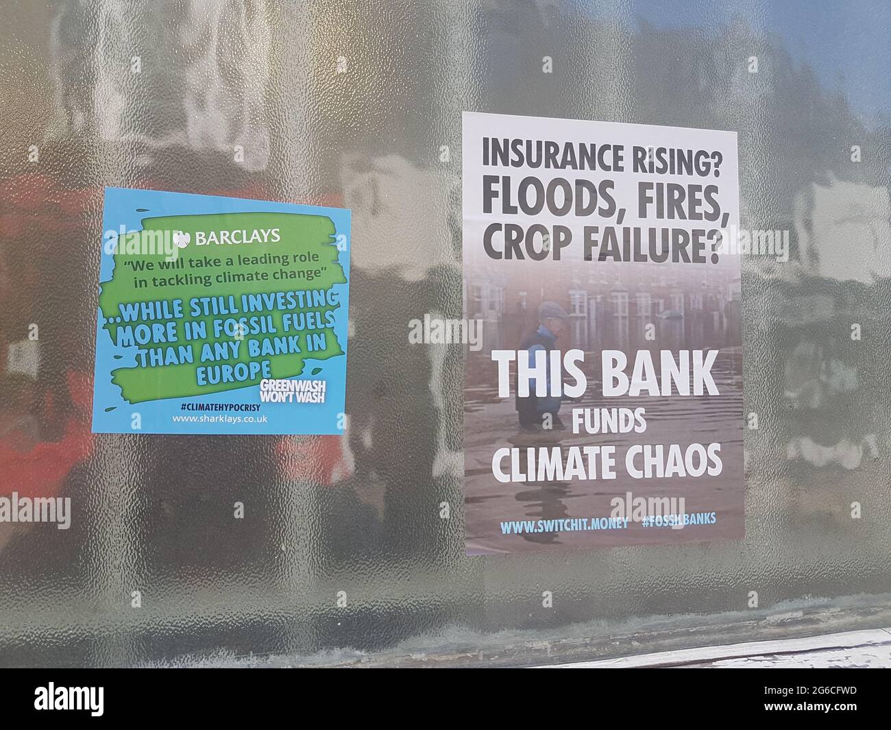 Woodbridge, Suffolk, UK July 05 2021: Extinction rebellion poster that has been put up on the walls of a HSBC bank claiming they fund climate crisis Stock Photo